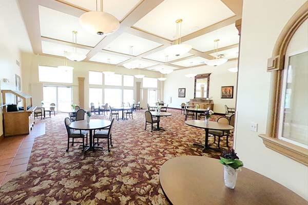 Apple Village indoor dining with large windows overlooking the scenic lake outside