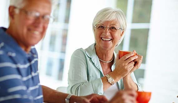 Smiling senior couple enjoying a cup of coffee